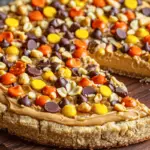 Peanut Butter Pizza Dessert with a sugar cookie crust, creamy peanut butter topping, chocolate chips, marshmallows, and drizzled caramel.