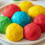 Homemade playdough in multiple colors, ready for creative play