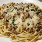 Savory garlic Parmesan beef mixed with spaghetti pasta, topped with melted cheese for a comforting and flavorful dish.