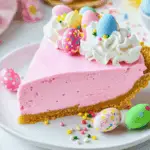 astel No-Bake Easter Jello Pie with whipped topping and mini Easter egg candies on a white plate.